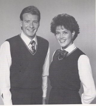 Both a sleeveless and long sleeve vest style sweater was issued in navy with gold trim around the V-neckline. The butcher style serving garm