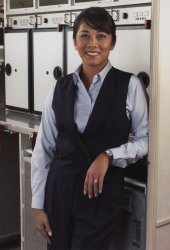 The matching suit vest with a notched collar buttoned at the waist featured two navy buttons embossed with the United logo and faux flap poc