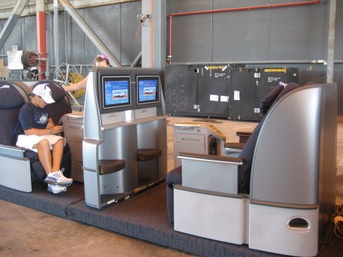 This young boy is testing out a mock up of United’s new international business class seats or pods as they have been called which customers 