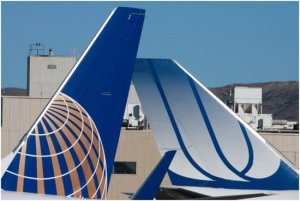 Left – Airplane tails of the newly merged companies (L – Continental and R – United) are positioned next to each other. Right - United’s new