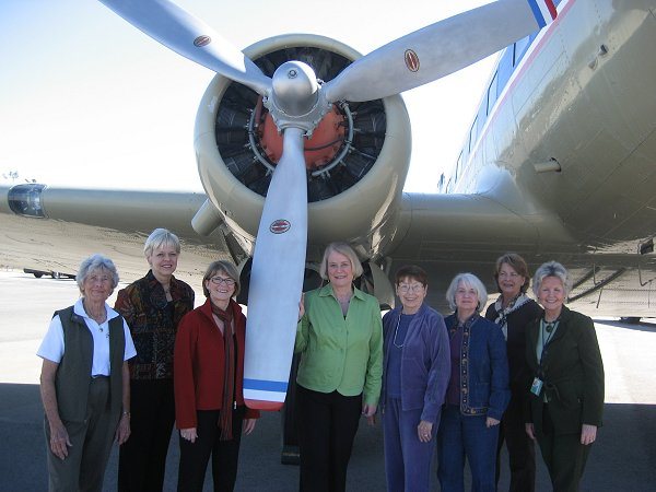 Under the wing of a vintage 1930s DC-3 that is on permanent display at the museum, the group is captured in one final pose. L-R: Ethel Patti