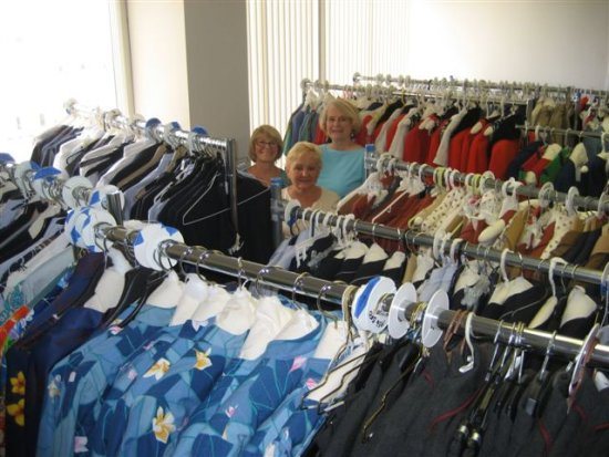 Volunteers Carole Tye, Linda Davis (Back L-R) and Marlene Dudek (Front) stand among a sea of vintage United Airlines uniforms being prepared