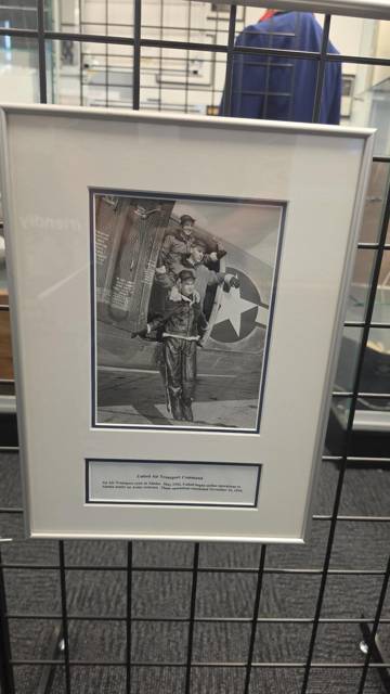 Framed photograph of airmen beside an aircraft