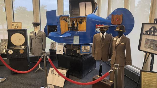 The blue Link Trainer, with pilot and flight attendant uniforms