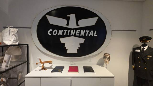Continental eagle sign above a display of binders and a model